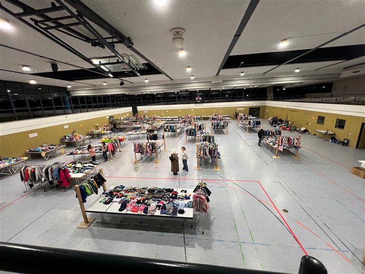 Flohmarkthalle während der Vorbereitung mit Helferinnen zwischen den Verkaufsständen